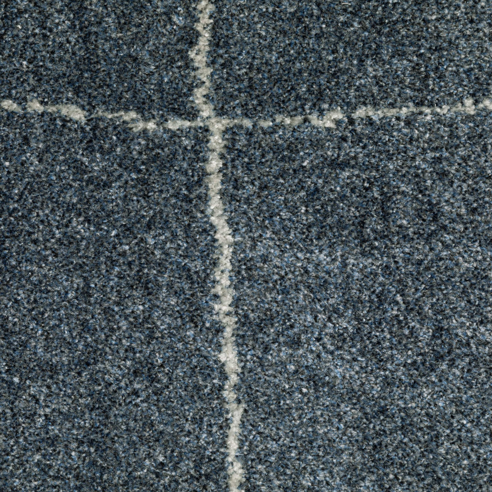 Alton Blue & Beige Casual Rug, close-up of dense, power-loomed polyester yarn with a white grid pattern.