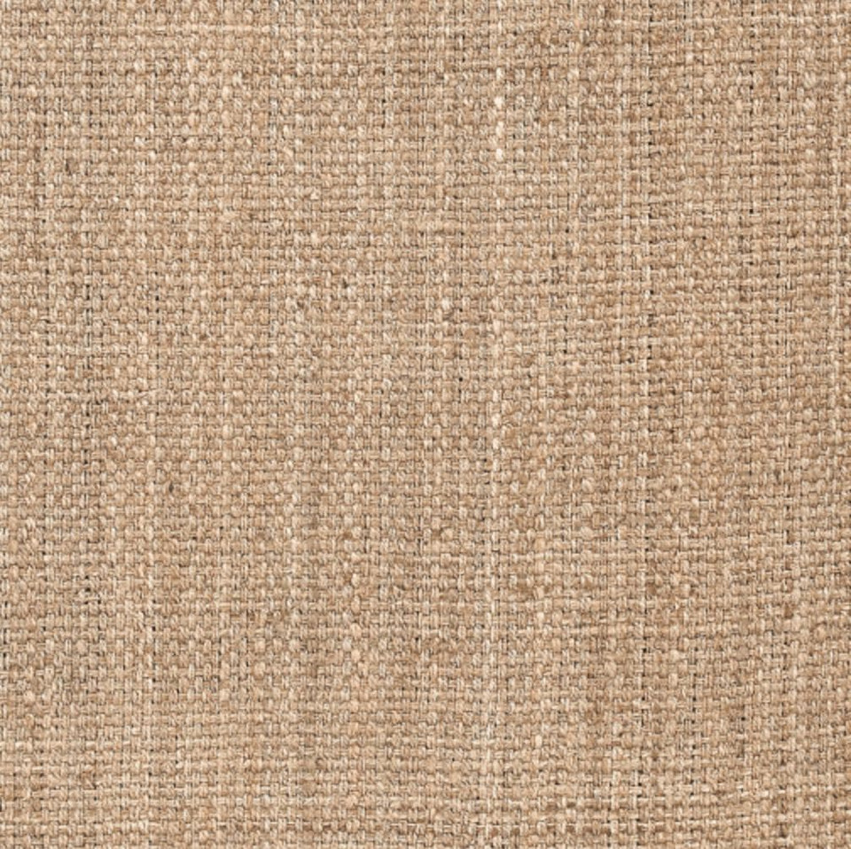 Close-up of a tan, hand-woven jute rug with a visible natural fiber texture.