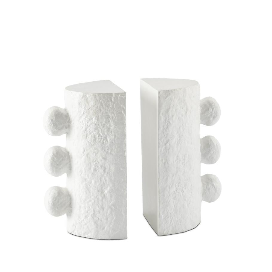 White cast metal Sanya Bookends with a paper mache-inspired texture and three spherical accents on each.