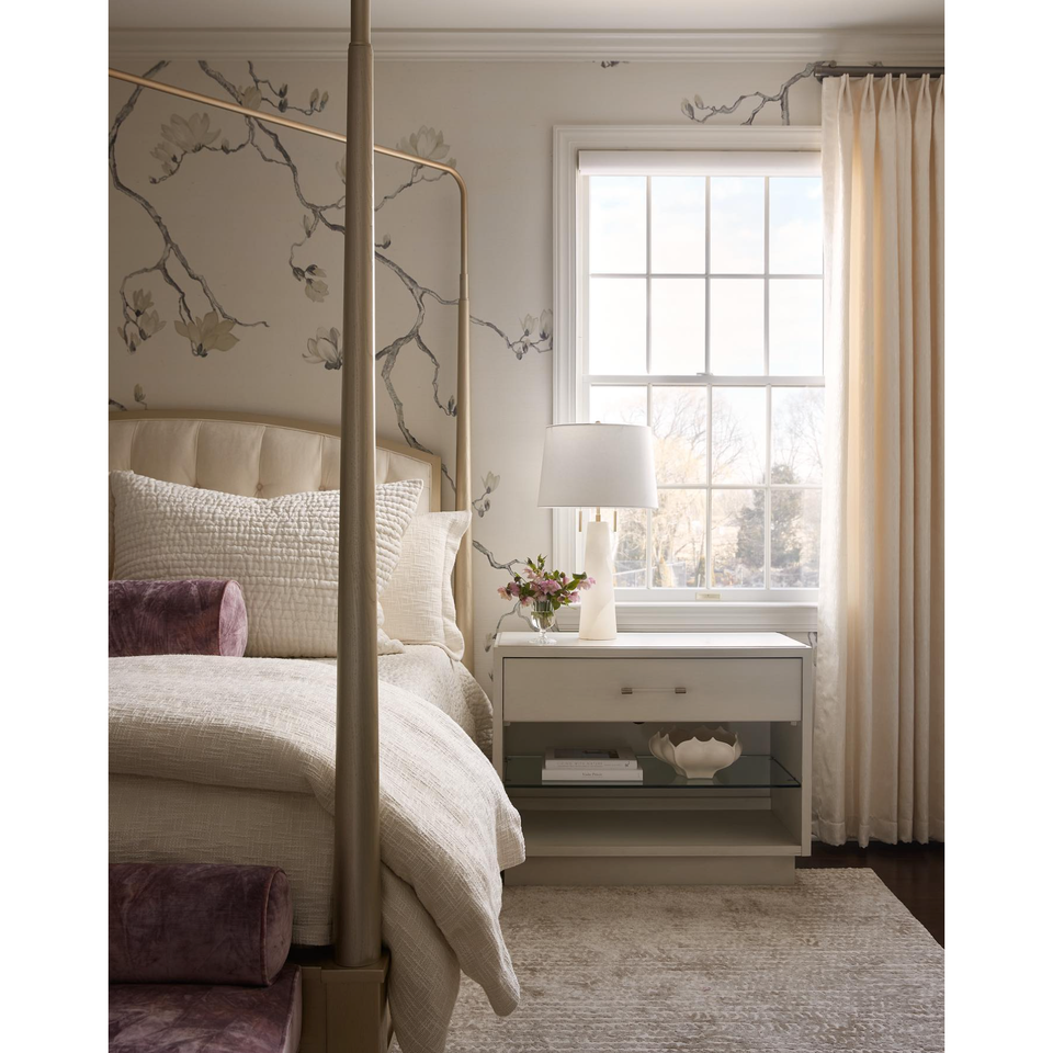 Austen Alabaster Table Lamp with a conical base and white linen shade on a modern nightstand.