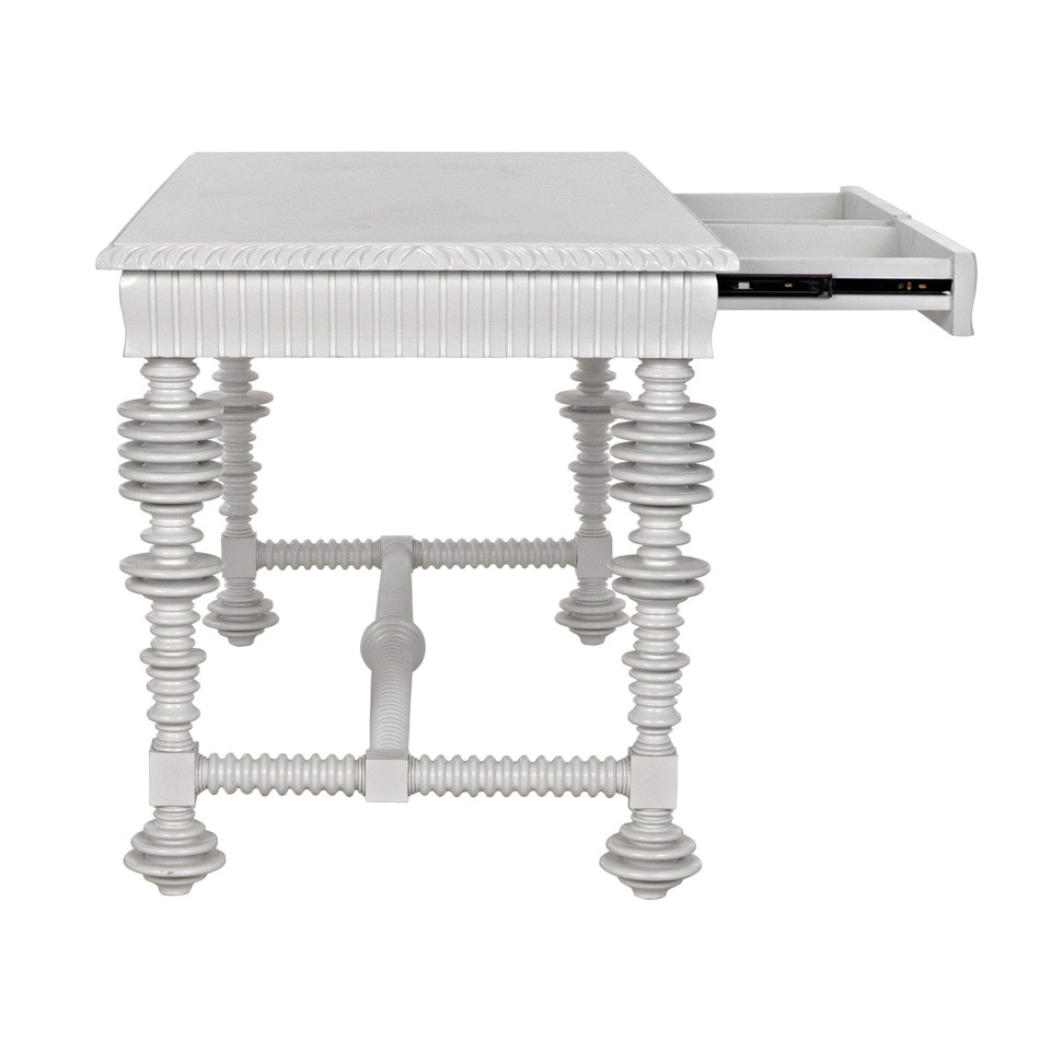 White mahogany office desk with spool-turned legs, carved apron, and an open drawer.