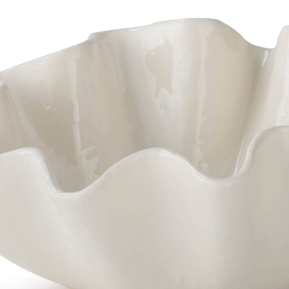 Large creamy white ceramic bowl with ruffled edges.
