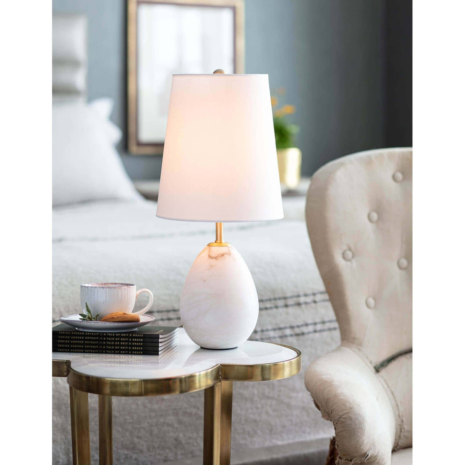Jared Alabaster Mini Lamp with oval, veined alabaster base, polished brass accents, and an elongated white linen shade.