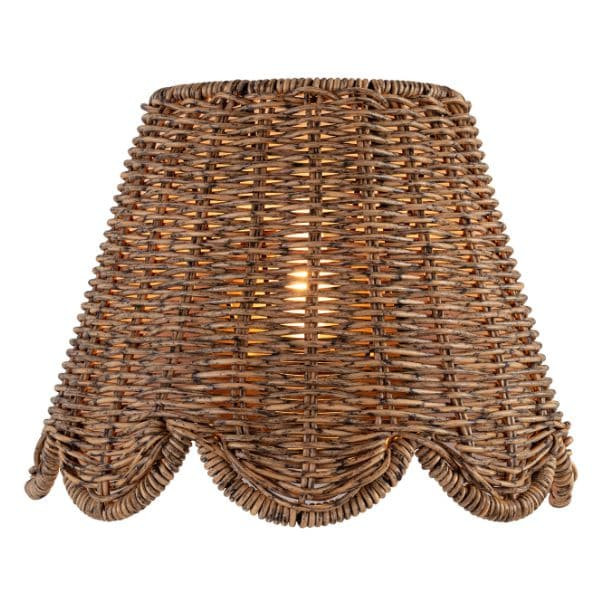 Kismet Sconce with a woven rattan-like shade and a scalloped bottom edge, emitting a warm glow.