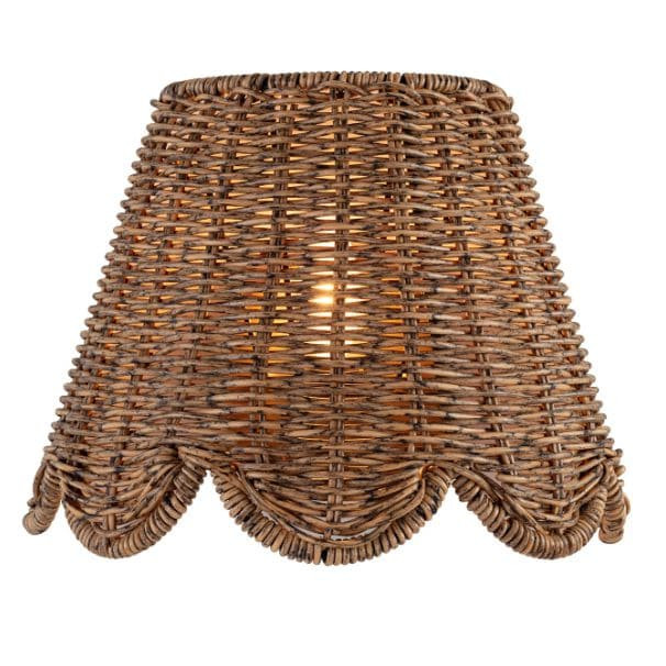 Kismet Sconce with a woven rattan-like shade, scalloped bottom edge, and warm glow.