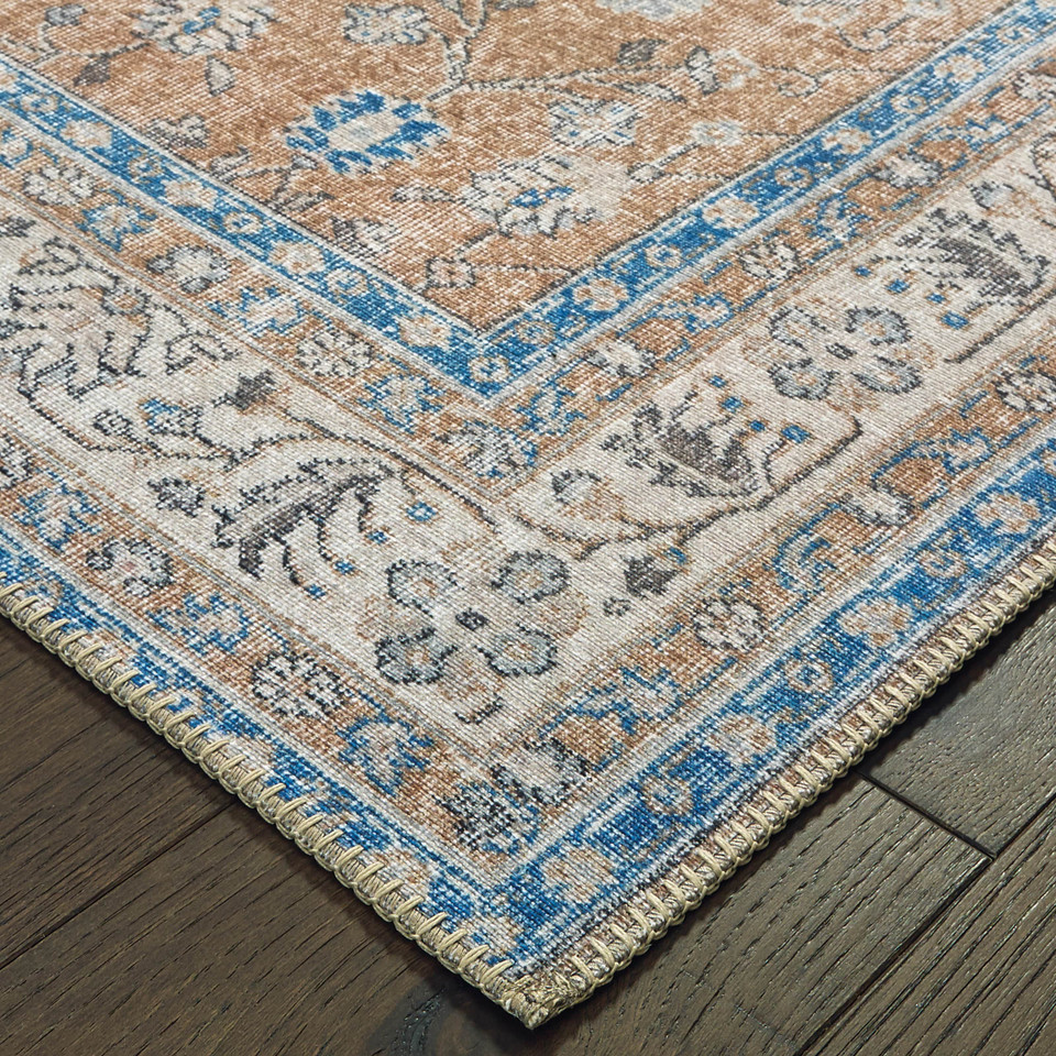 Sofia Gold & Blue Traditional Rug with antique-inspired floral design, intricate blanket stitch, on wood floor.