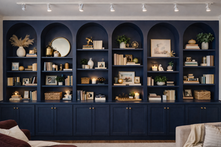 Custom built ins bookcase with floor-to-ceiling shelving designed by Ariel Arts