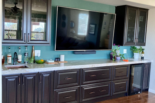 Custom built ins bar and coffee nook with dark stained wood raised panel doors