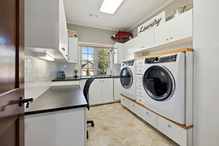 Custom built ins laundry room in a recessed wall with compact storage