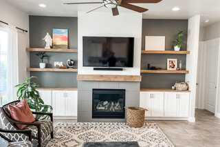 Contractor-built custom built ins media center with fireplace cabinets and floating shelves by Chris Y.