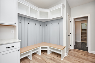 Custom mudroom built-ins with bench seating and closed storage cabinets
