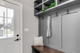 Custom mudroom built-ins with white shaker cabinets and bench seating