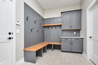 Custom mudroom built-ins with open cubbies and closed cabinets