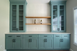 custom built ins tall china cabinet with blue shaker doors adjustable shelving crown molding and wood floating shelves