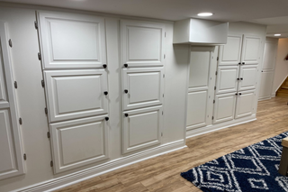 custom built ins basement storage with white raised panel cabinet doors