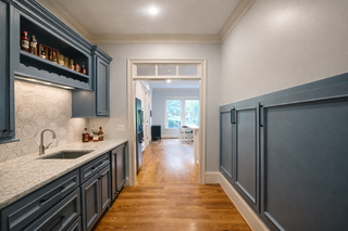 custom built ins butler pantry with blue flat panel doors crown molding and adjustable shelving