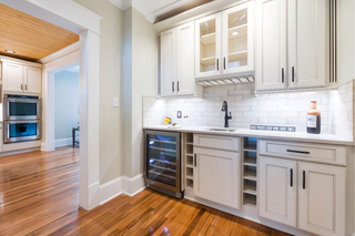 custom built ins flat panel cabinets with glass doors and built-in mini fridge