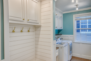 custom built ins laundry room upper cabinets with white raised panel doors