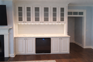 custom built ins raised panel cabinets with glass ready doors and under cabinet lighting