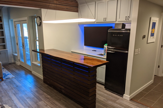 custom built ins grey shaker basement bar nook with crown molding and built-in cabinets