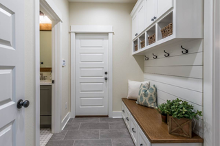 custom built ins mudroom with white shaker cabinets and built-in storage