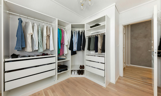 Custom closet built-ins with drawers, shelving, cabinetry, and double hanging storage
