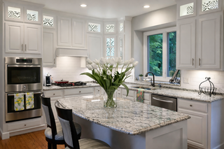 Custom kitchen cabinets in bright white extended to the ceiling in a real-life Ferowich kitchen project