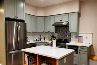 Custom kitchen cabinets in sage green super matte thermofoil by customer Stephen in a modernized kitchen