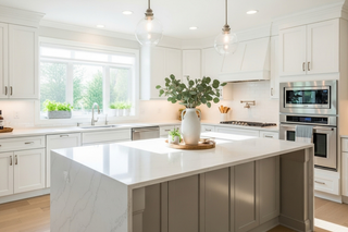 Custom kitchen island with grey shaker panels and quartz countertop paired with white shaker cabinets for contrast