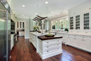 Custom kitchen island with large drawer storage and white shaker panels built for entertaining and organization