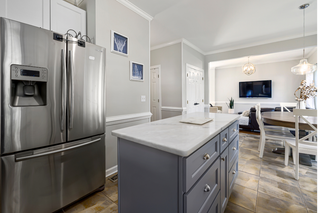 Custom kitchen island with oxford gray shaker doors and slab panels for mixed-style modern design