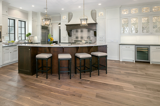 Custom kitchen island with walnut shaker panels and curved island shape for a premium furniture-style design
