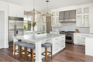 Custom kitchen island with white shaker drawers and bar seating for everyday family use and hosting
