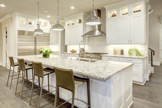 Custom kitchen island with white shaker panels and marble countertops for an elevated traditional look