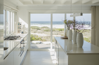 Custom kitchen island with high gloss white slab panels for a sleek contemporary kitchen design