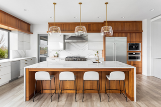 Custom kitchen island with wood shaker panels and quartz countertop for durable everyday prep and entertaining
