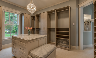 Luxury custom closet with center island and wall-to-wall built-in cabinetry