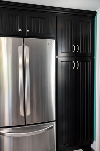 Modern black beaded kitchen cabinets with tall refrigerator cabinets