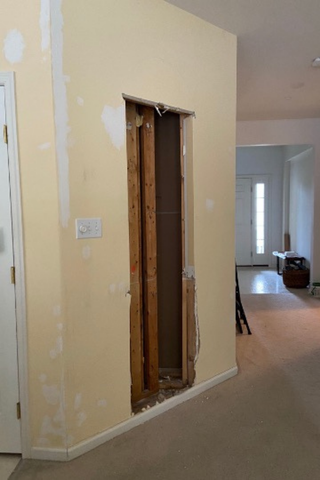 Custom built-ins recessed wall cabinetry with drawers and charging storage