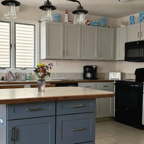 Vincent's finished shaker cabinet doors in Mindful Gray paired with Midnight Grey