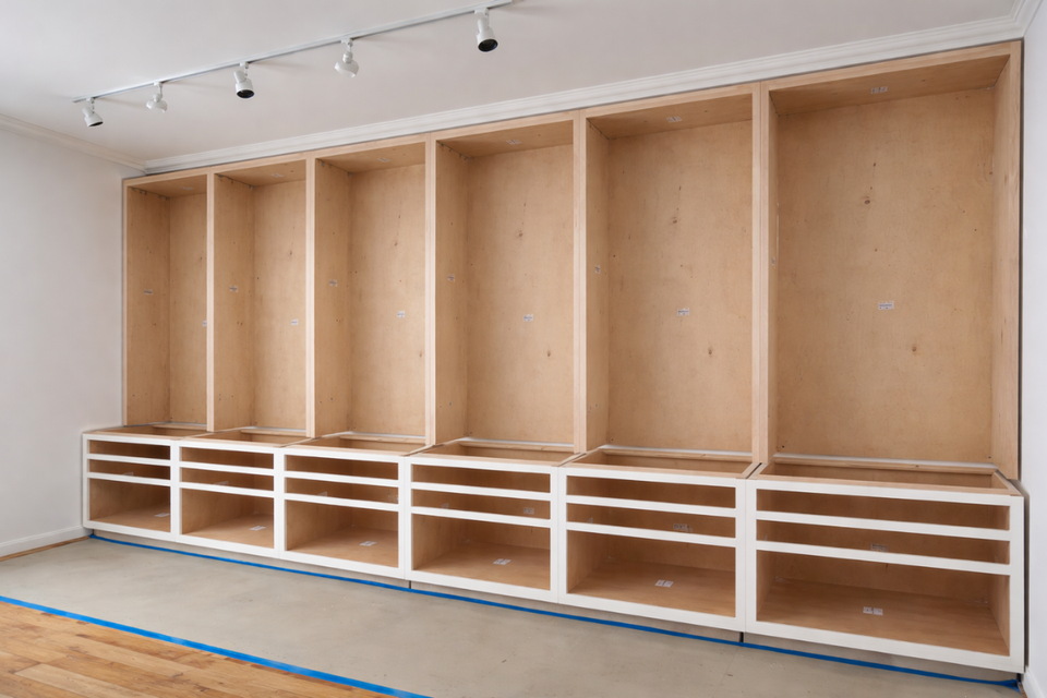 Custom built ins bookcase detail with blue shelving and integrated storage designed by Ariel Arts studio