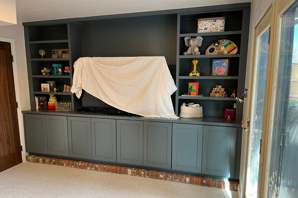 Custom built-in cabinets installed as an entertainment center in Charles’ real life project