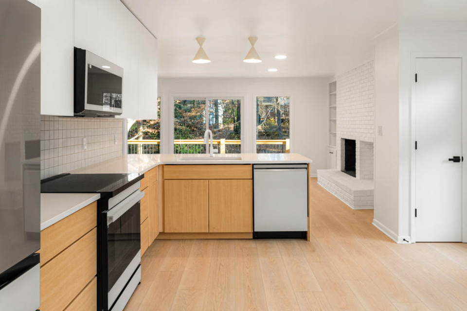 Custom kitchen cabinets with Modern Turino slab design and white countertops in a Scandinavian-inspired kitchen