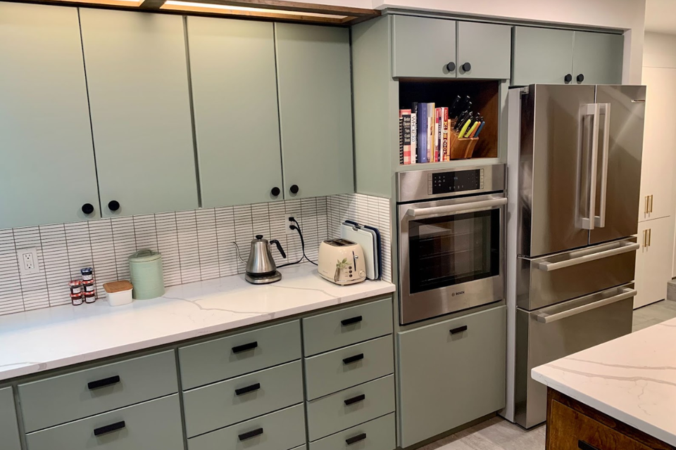 Custom kitchen cabinets with sage Modern Turino cabinet doors in a mid century modern kitchen layout
