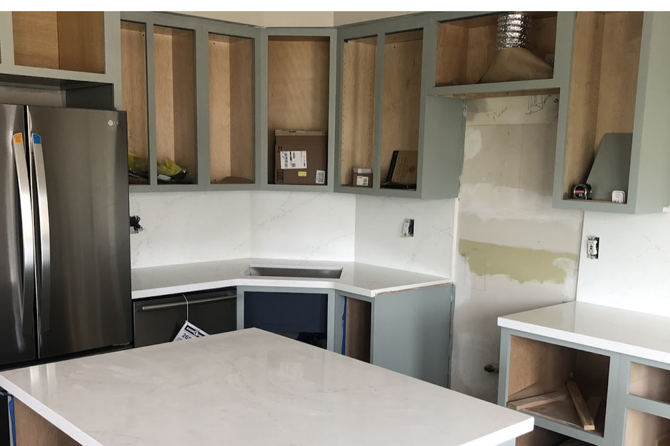 Finished custom kitchen cabinets project with sage green shaker thermofoil and functional island