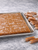 Large batch of sea salt caramels cooling on a marble slab

