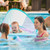 Family enjoying the SwimWays Baby Spring Pool Float with Canopy - Mermaid