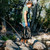 Hiker carrying his Mission CASSI Dual Compartment 18L Backpack over a stream