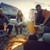 Group of friends sitting around a campfire drinking out of their Dometic Stainless Steel Cups