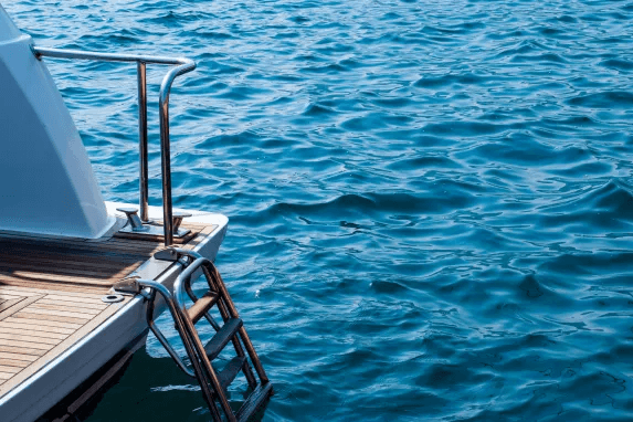 Stainless steel boat ladder extending into the water.